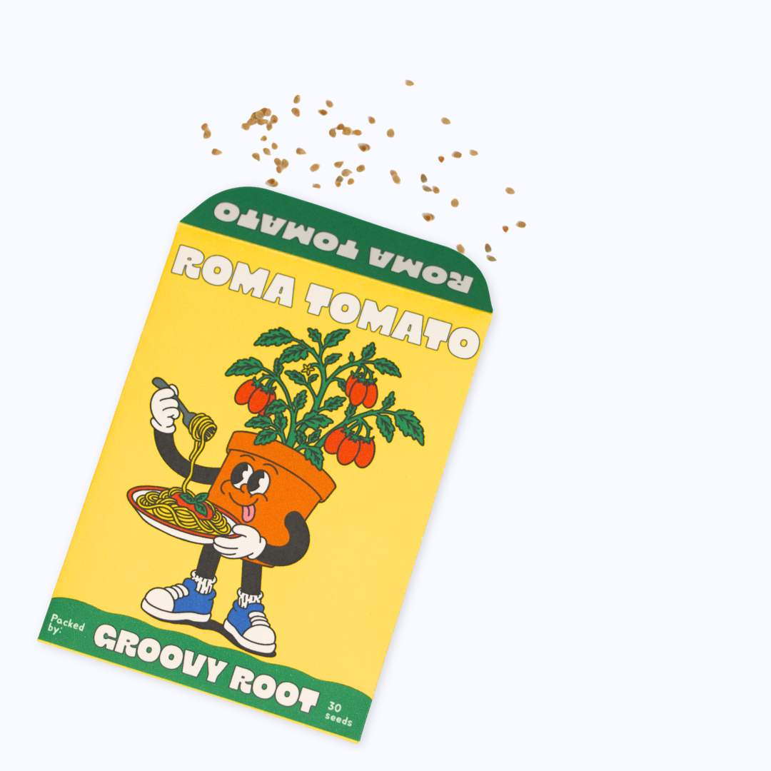A novelty seed packet for Roma Tomato, featuring a yellow background, green borders, and a cartoon tomato plant character. Small tomato seeds are scattered above the packet on a clean white background.