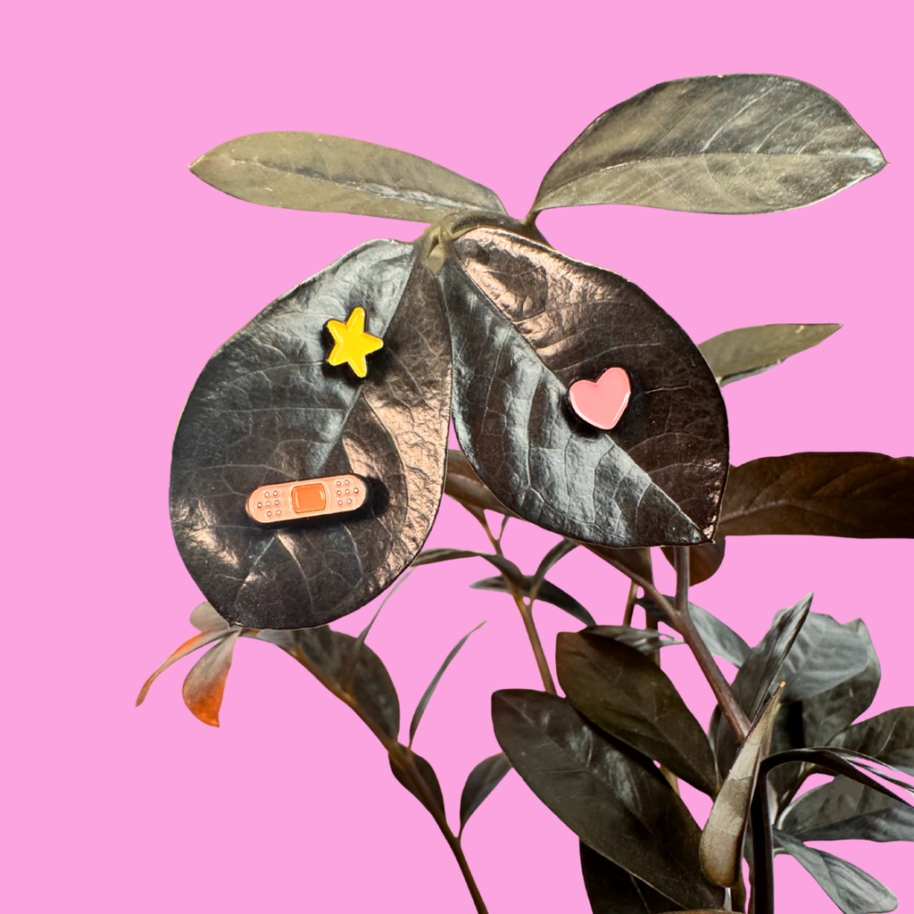 Collage of leaves with magnets on a pink background