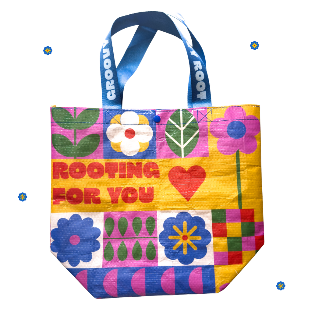 Colorful tote bag with floral patterns and 'Rooting for You' text on a white background