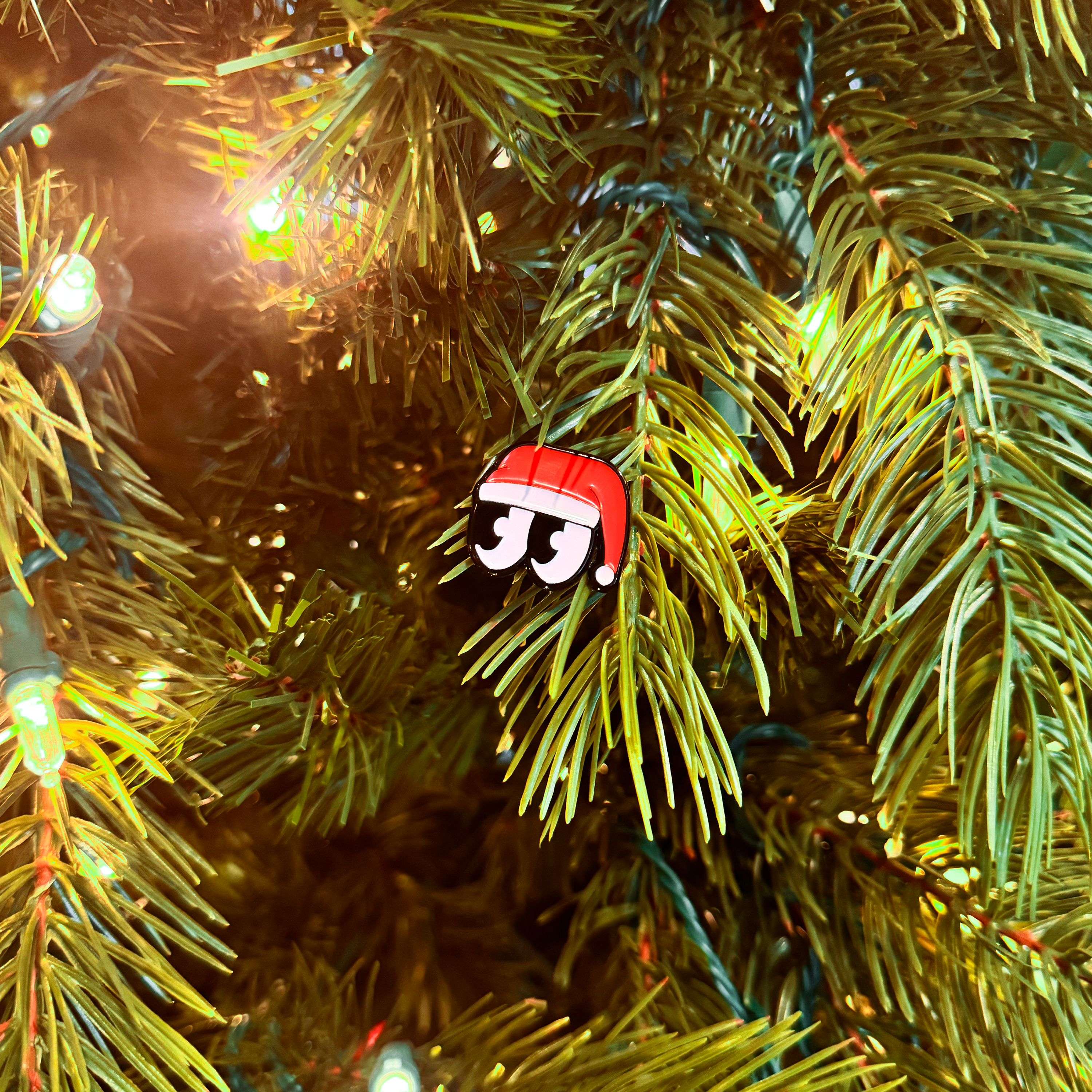 Decorative ornament with Santa hat on a Christmas tree